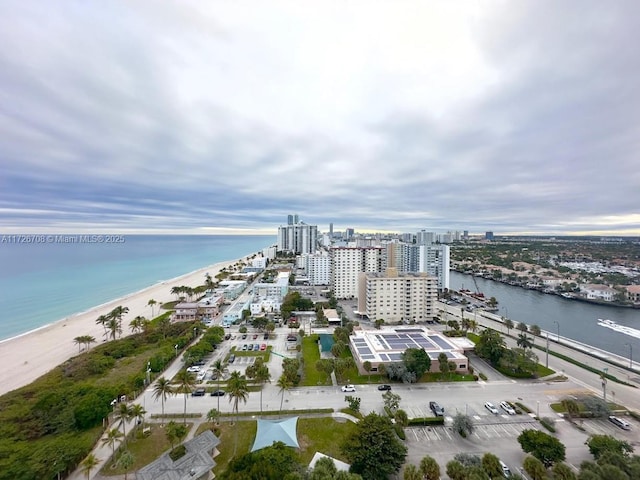 drone / aerial view featuring a beach view and a water view