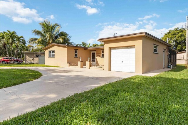 single story home featuring a garage and a front lawn