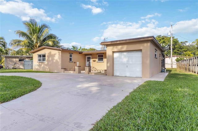 view of front of property with a garage and a front lawn