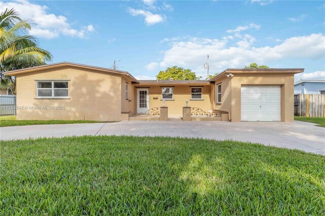 view of front of property with a garage and a front yard