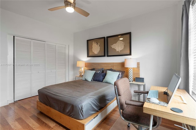 bedroom with ceiling fan, a closet, and wood-type flooring