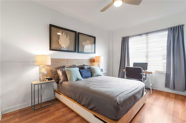 bedroom with hardwood / wood-style floors and ceiling fan