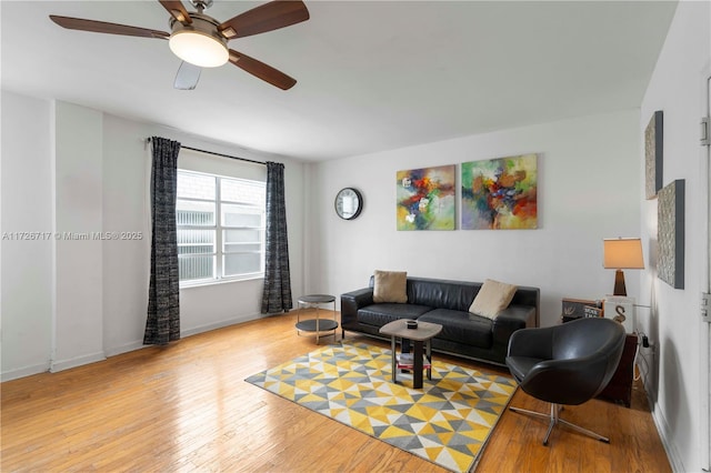 living room with light hardwood / wood-style floors and ceiling fan