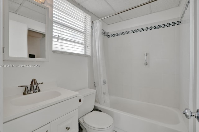 full bathroom featuring toilet, vanity, a drop ceiling, and shower / bath combination with curtain