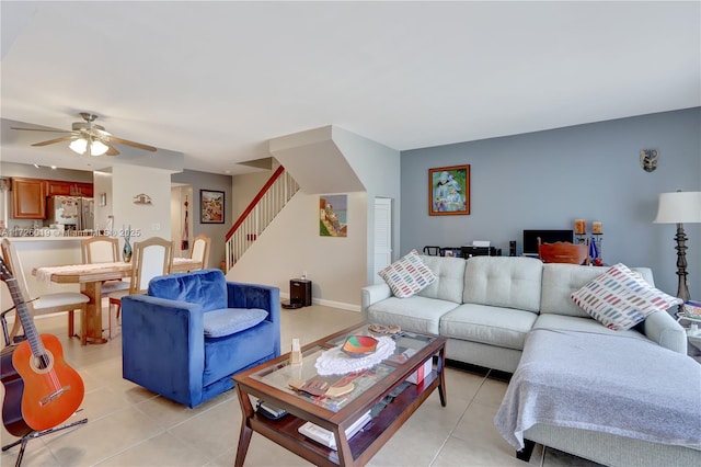 living room with ceiling fan and light tile patterned flooring