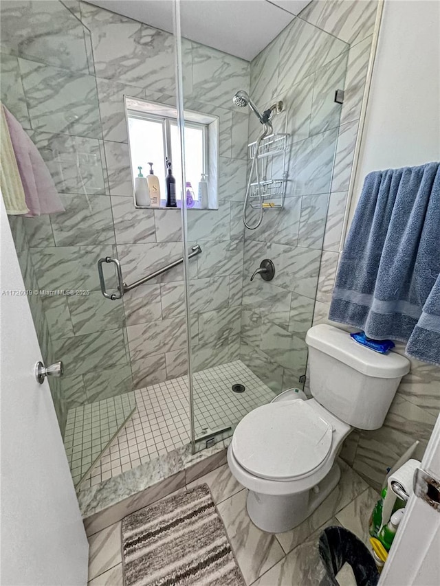 bathroom featuring toilet and walk in shower