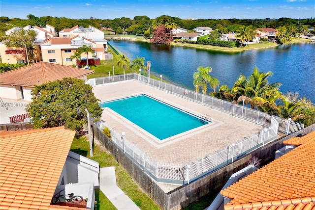 view of pool featuring a water view