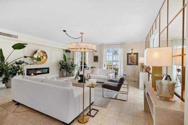 living room featuring crown molding and a chandelier