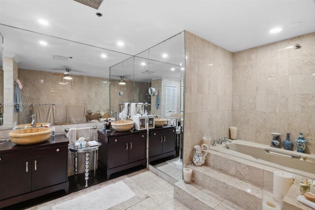 bathroom featuring tile walls, ceiling fan, and vanity