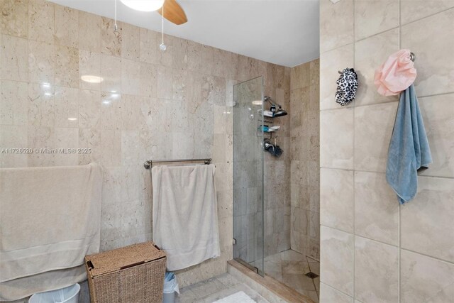 bathroom with an enclosed shower and ceiling fan