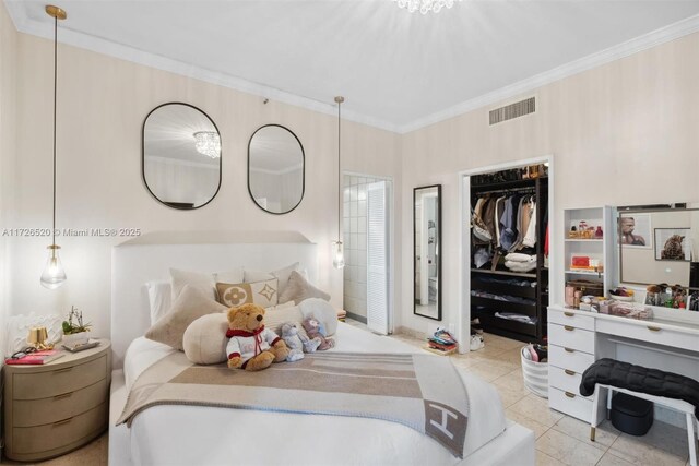 tiled bedroom with crown molding, a closet, and ensuite bath