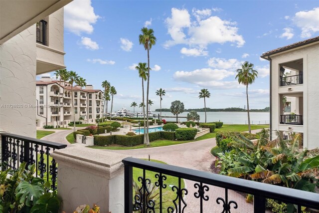 view of community with a swimming pool and a water view