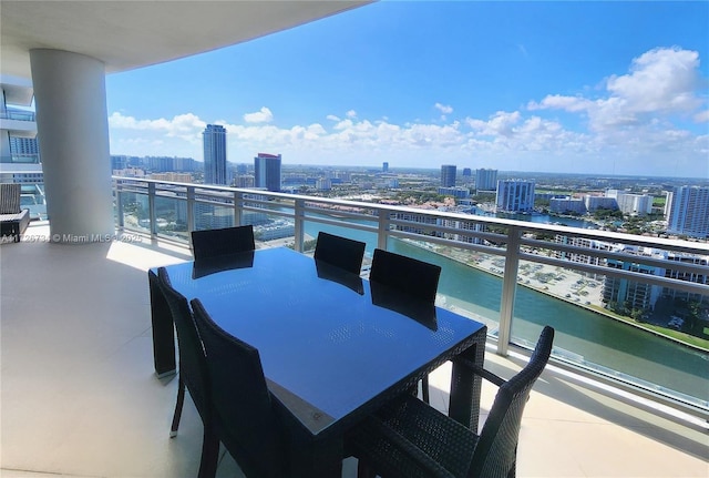 balcony featuring a view of city and a water view