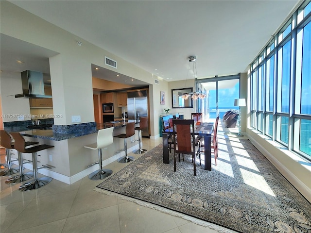 dining space featuring light tile patterned floors and a chandelier