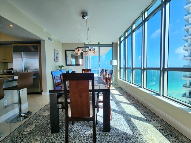 tiled dining space featuring a chandelier