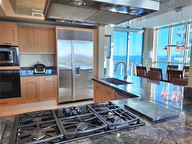 3535 S Ocean Dr Unit 2805, Hollywood, FL 33019 - kitchen featuring black appliances, a sink, light brown cabinetry, and dark stone countertops