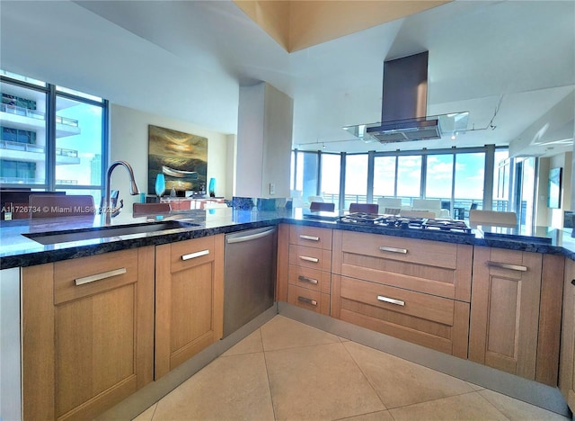 kitchen featuring kitchen peninsula, island range hood, sink, appliances with stainless steel finishes, and light tile patterned flooring