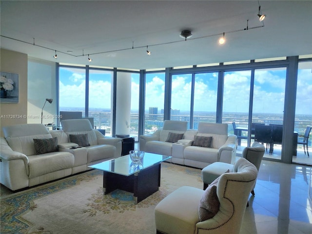 living room with a wall of windows, light tile patterned floors, and rail lighting