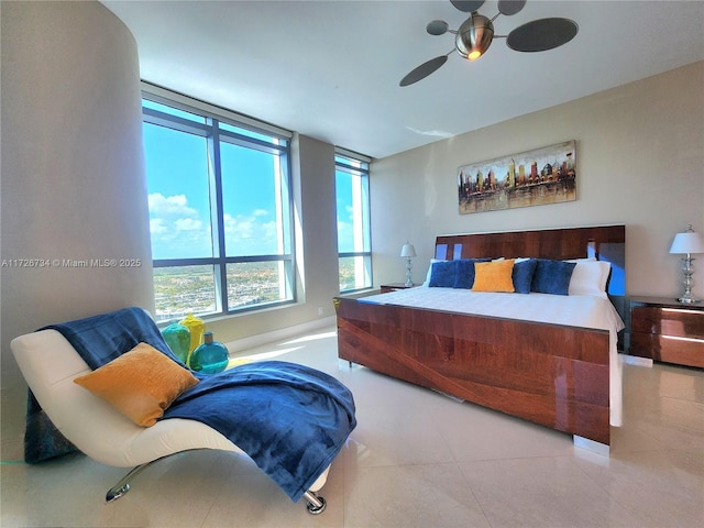 tiled bedroom featuring ceiling fan