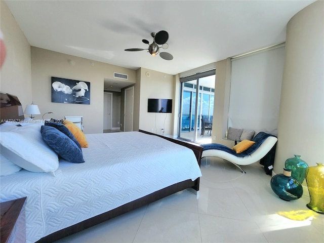 tiled bedroom with ceiling fan and access to exterior