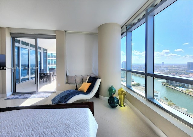 bedroom with a water view and access to outside