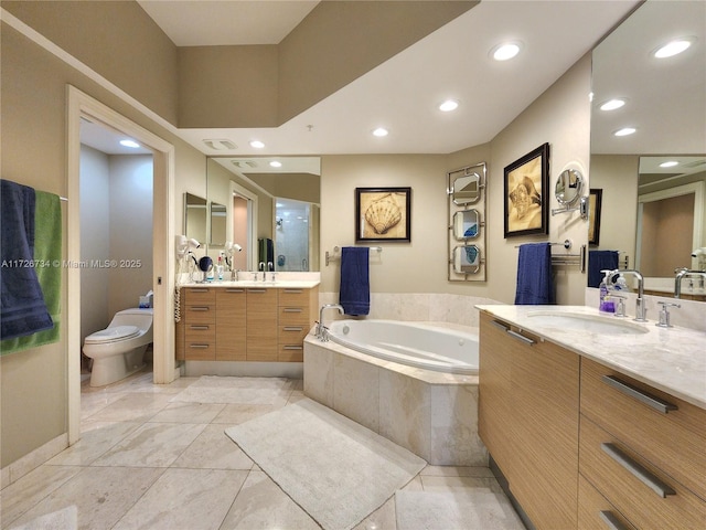 full bathroom featuring vanity, shower with separate bathtub, and toilet