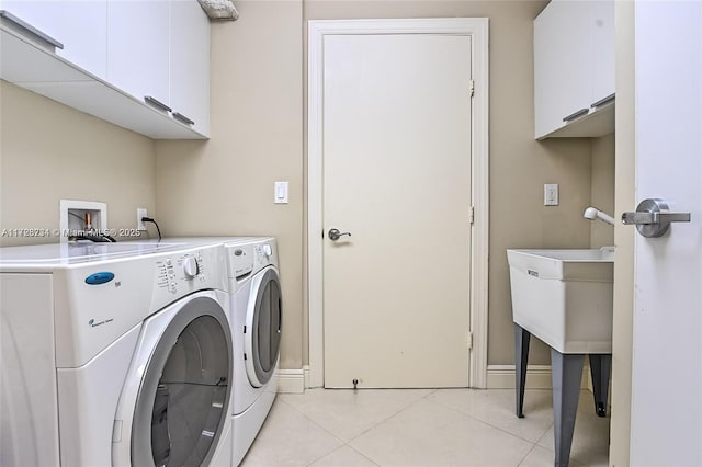 3535 S Ocean Dr Unit 2805, Hollywood, FL 33019 - washroom featuring cabinet space, light tile patterned flooring, separate washer and dryer, and baseboards
