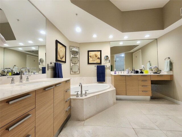 bathroom featuring vanity, tile patterned floors, and tiled bath