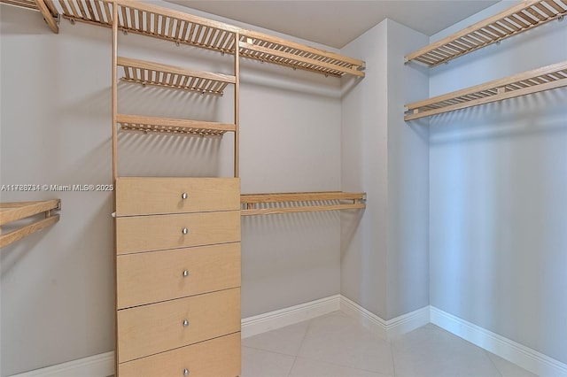 spacious closet with light tile patterned floors