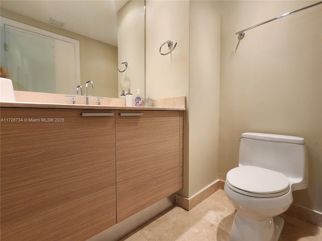 bathroom featuring tile patterned floors, toilet, and vanity