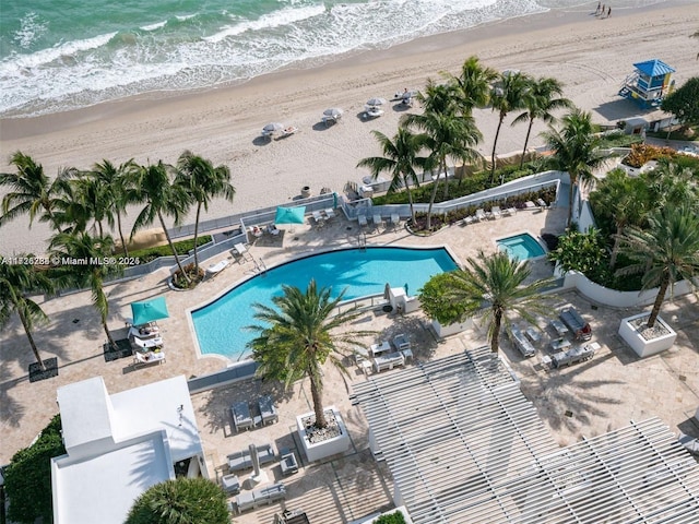 view of pool featuring a water view and a view of the beach