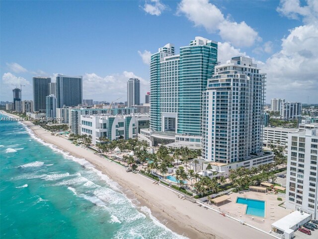 aerial view with a water view and a beach view