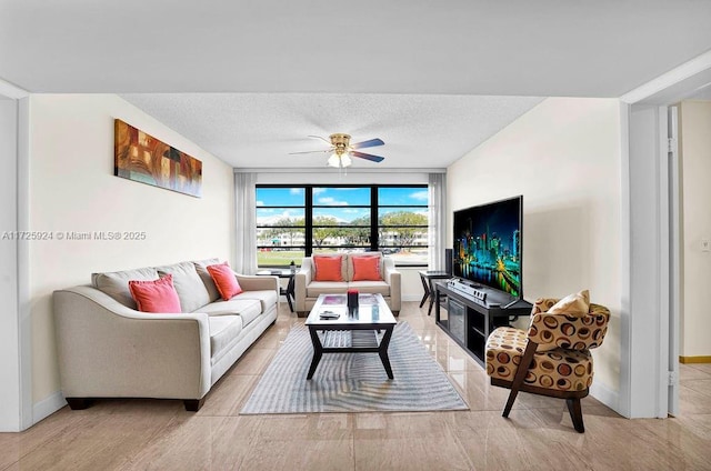 living room featuring a textured ceiling and ceiling fan