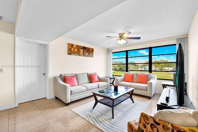 tiled living room featuring a textured ceiling and ceiling fan