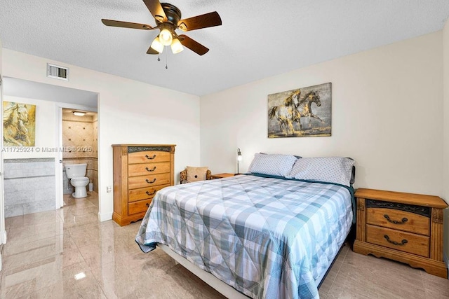 bedroom with ceiling fan, connected bathroom, and a textured ceiling