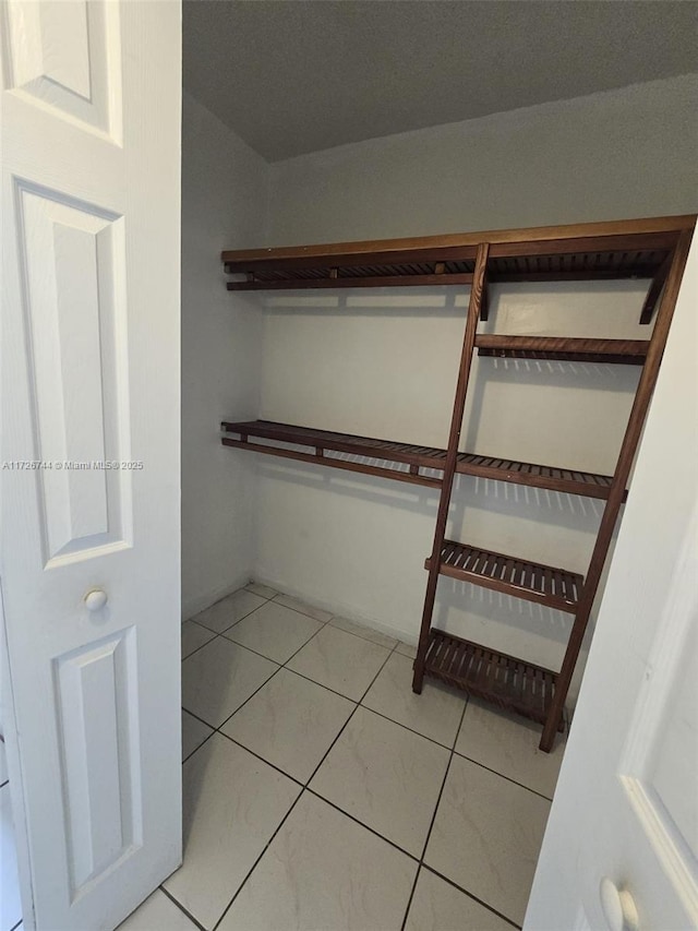 spacious closet with tile patterned flooring