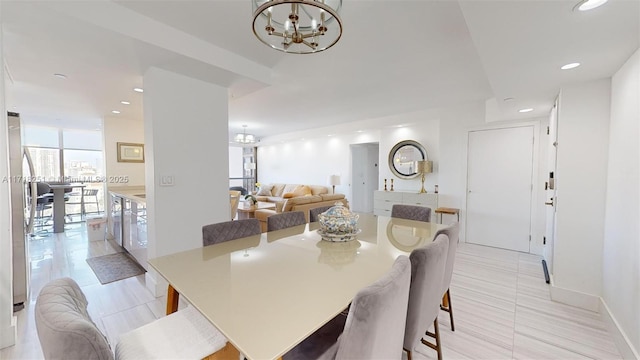 tiled dining room with a wall of windows and a notable chandelier