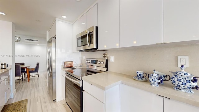 kitchen featuring appliances with stainless steel finishes and white cabinetry