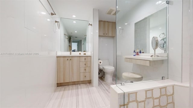 bathroom featuring toilet and vanity