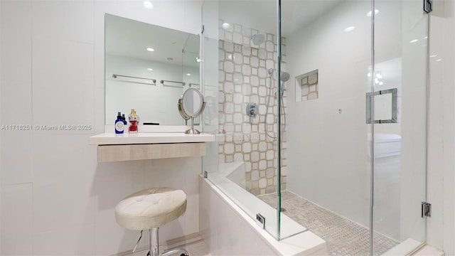 bathroom with vanity and a shower with shower door