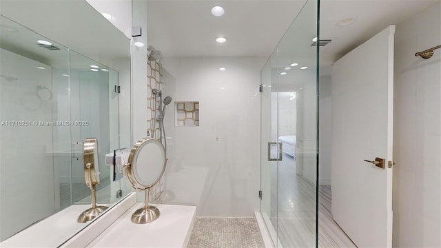 bathroom with an enclosed shower and tile patterned floors