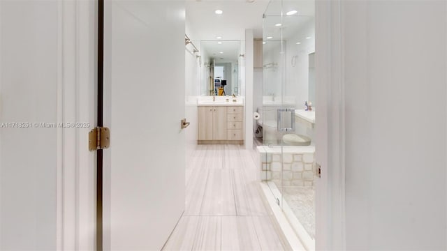 bathroom featuring walk in shower, vanity, tile patterned floors, and toilet