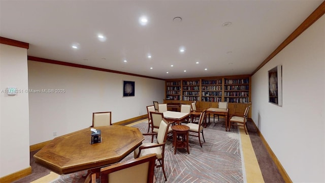 dining space with built in features and ornamental molding