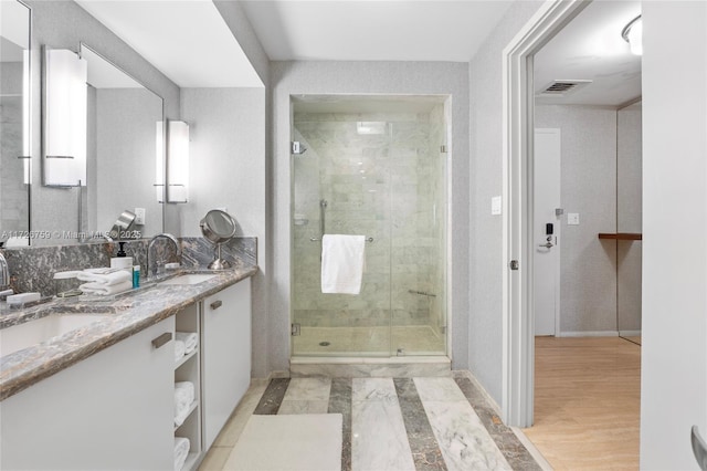 bathroom with an enclosed shower and vanity