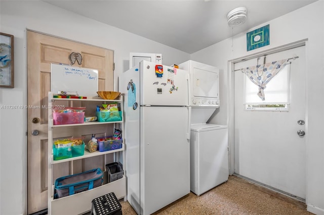 clothes washing area featuring stacked washer / drying machine