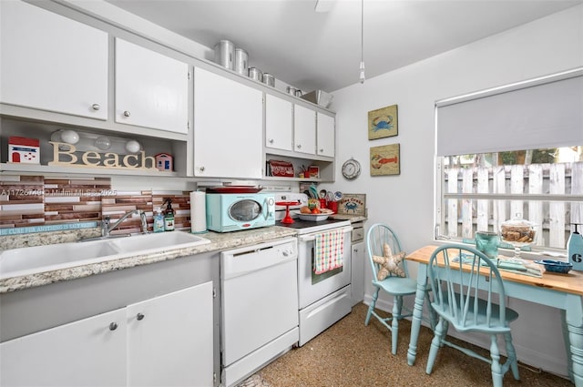 kitchen with white appliances, white cabinets, and sink