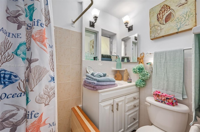 bathroom with tile walls, a shower with shower curtain, vanity, and toilet