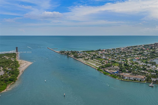 drone / aerial view featuring a beach view and a water view