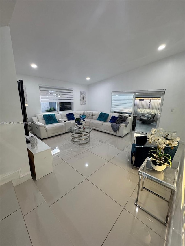 living room with tile patterned flooring and lofted ceiling