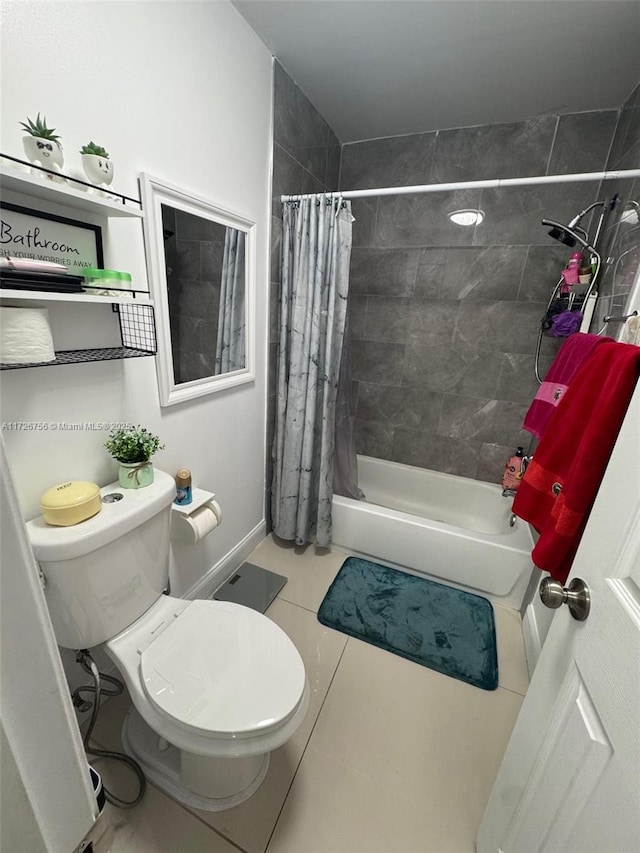 bathroom featuring a shower with curtain, tile patterned floors, and toilet